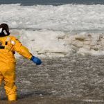 A Sandusky firefighter tosses away a block of ice